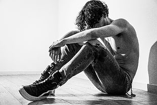 greyscale photo of a man topless sitting on a floor HD wallpaper