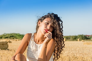 woman in white lace tank top sitting on hay field during daytime HD wallpaper