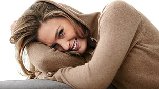 woman wearing brown sweater