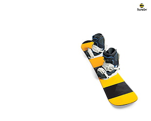 yellow and black snowboard with snowboard boots