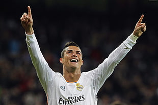 Cristiano Ronaldo smiling while raising both hands during soccer game