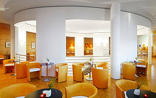 interior photography of dining hall with orange chairs and snack tables