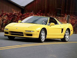 yellow sports car on concrete road