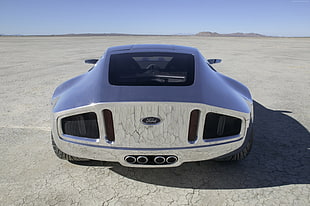 silver Ford super car on desert under clear sky