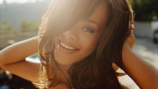 Rihanna holding her hair