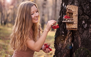 woman' in blonde hair holding berries