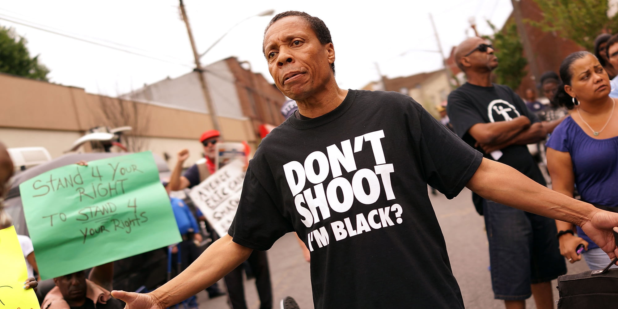 man in black and white Don't Shoot I'M Black? printed crew-neck t-shirt standing