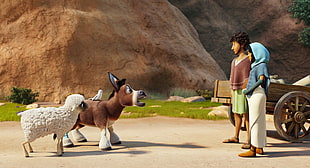 man and woman standing while facing brown and white donkey