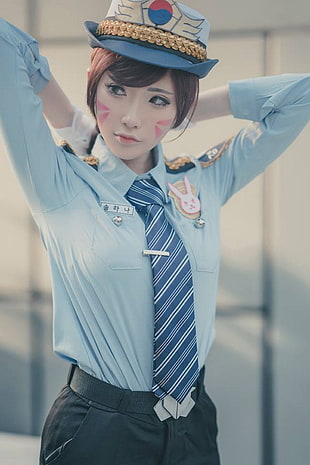 photo of woman wearing blue dress shirt, necktie, and black bottoms