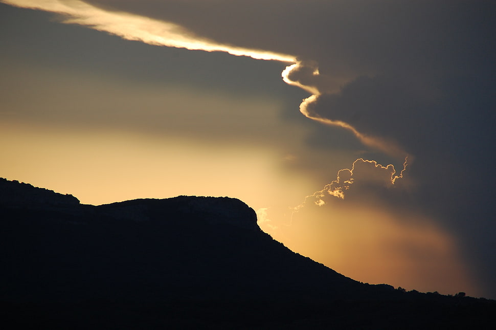 silhouette of mountain during sunset HD wallpaper