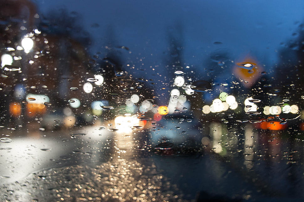 shallow focus of droplets on clear glass window during nighttime HD wallpaper