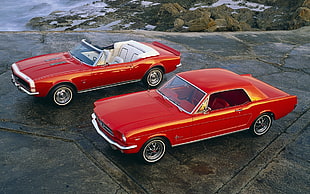 red muscle car and convertible car