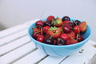 Strawberry and cherry on bowl