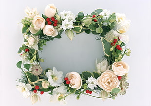 artificial white and pink wreath on white wall