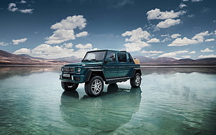 teal Mercedes-Benz jeep on body of water under cloudy sky during daytime HD wallpaper