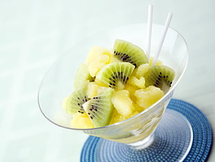 sliced kiwi fruits in footed glass container
