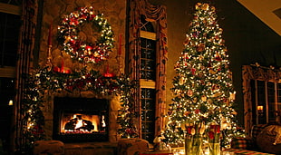 holiday tree full of ornaments and string lights near fireplace HD wallpaper