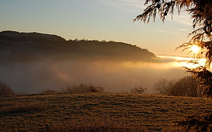 fogs on mountains during sunrise