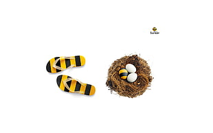pair of yellow-and-black striped flip-flops, white background, eggs, minimalism