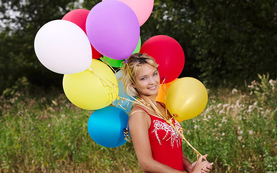 woman holding assorted colors of balloons and wearing red spaghetti strap HD wallpaper
