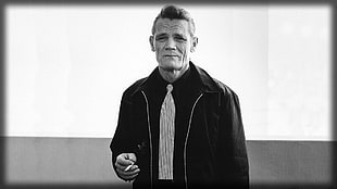 grayscale photo of man in black zip-up jacket