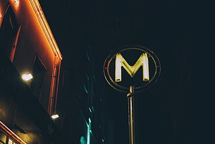 yellow letter M neon signage