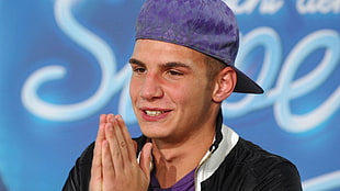 man wearing purple snapback cap
