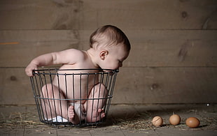 photography of baby on basket