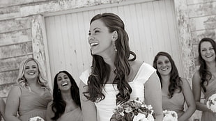 grayscale of bride holding flower