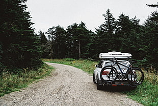 white SUV and two black and white mountain bikes HD wallpaper