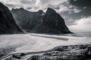 grayscale photography of mountains near beach