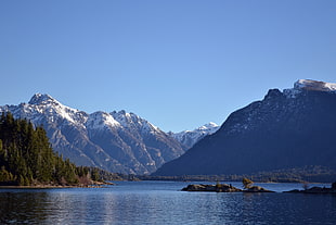 photo of mountains and body of water during daytime