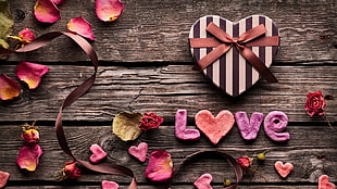 petaled flowers and heart gift box on wooden pallet