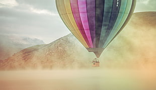 hot air balloon on foggy body of water