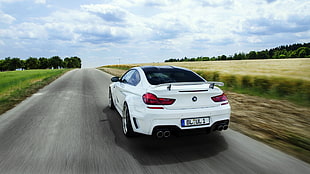 time lapse photography of white coupe