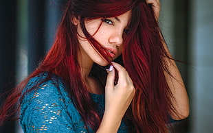 macro photography of woman with red hair wearing blue tops