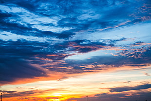 sunset under blue and grey cloudy sky