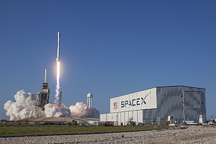 Space X building, SpaceX, rocket, smoke, American flag