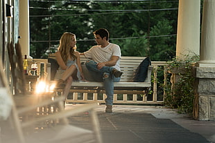 man and woman sitting on swing bench on terrace