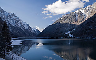 panoramic photography of mountain coated snow and lake during daytime