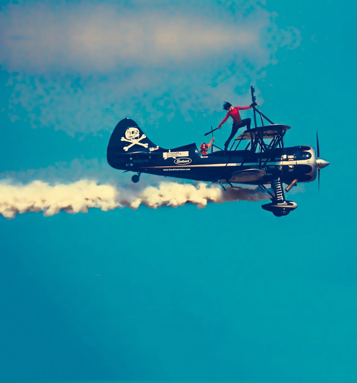 time lapse photography of person standing on biplane, airplane, sky show, smoke, war