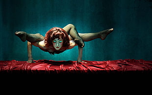 Acrobat woman on red table cloth