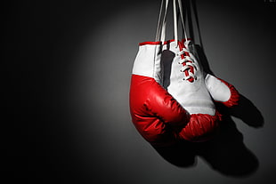 white-and-red leather training gloves hanging
