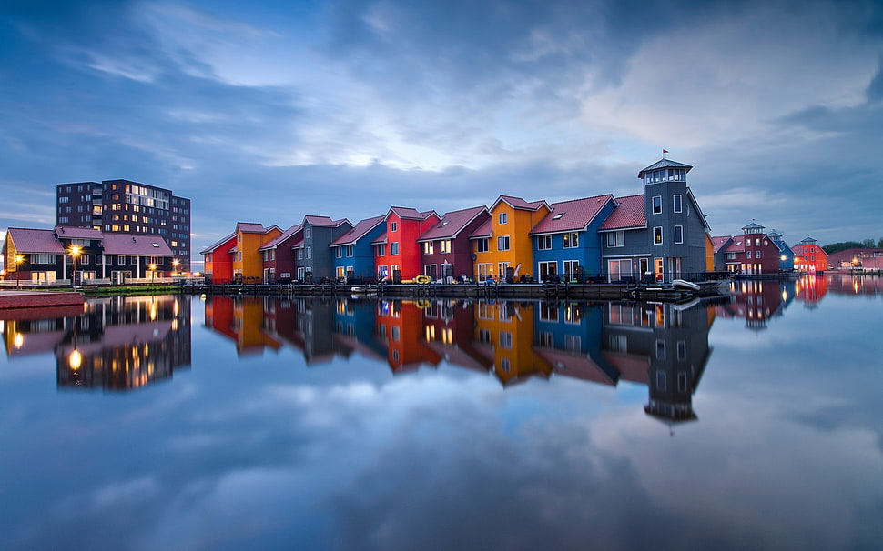 photo of assorted-color house on body of water HD wallpaper