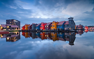 photo of assorted-color house on body of water