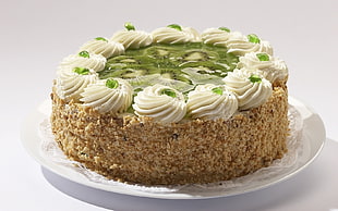 brown and white cake with slice of kiwi