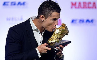 Cristiano Ronaldo kissing the gold cleat trophy