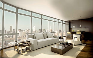 white fabric 2-seat sofa near glass wall