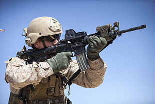 Military Personnel carrying black M4A1 rifle