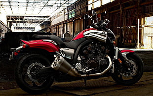 red, black, and chrome cruiser motorcycle